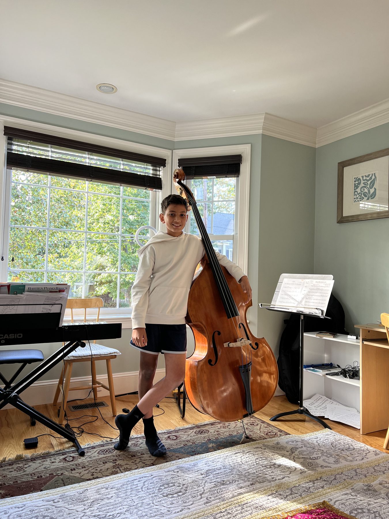 A young me posing with my upright bass at home