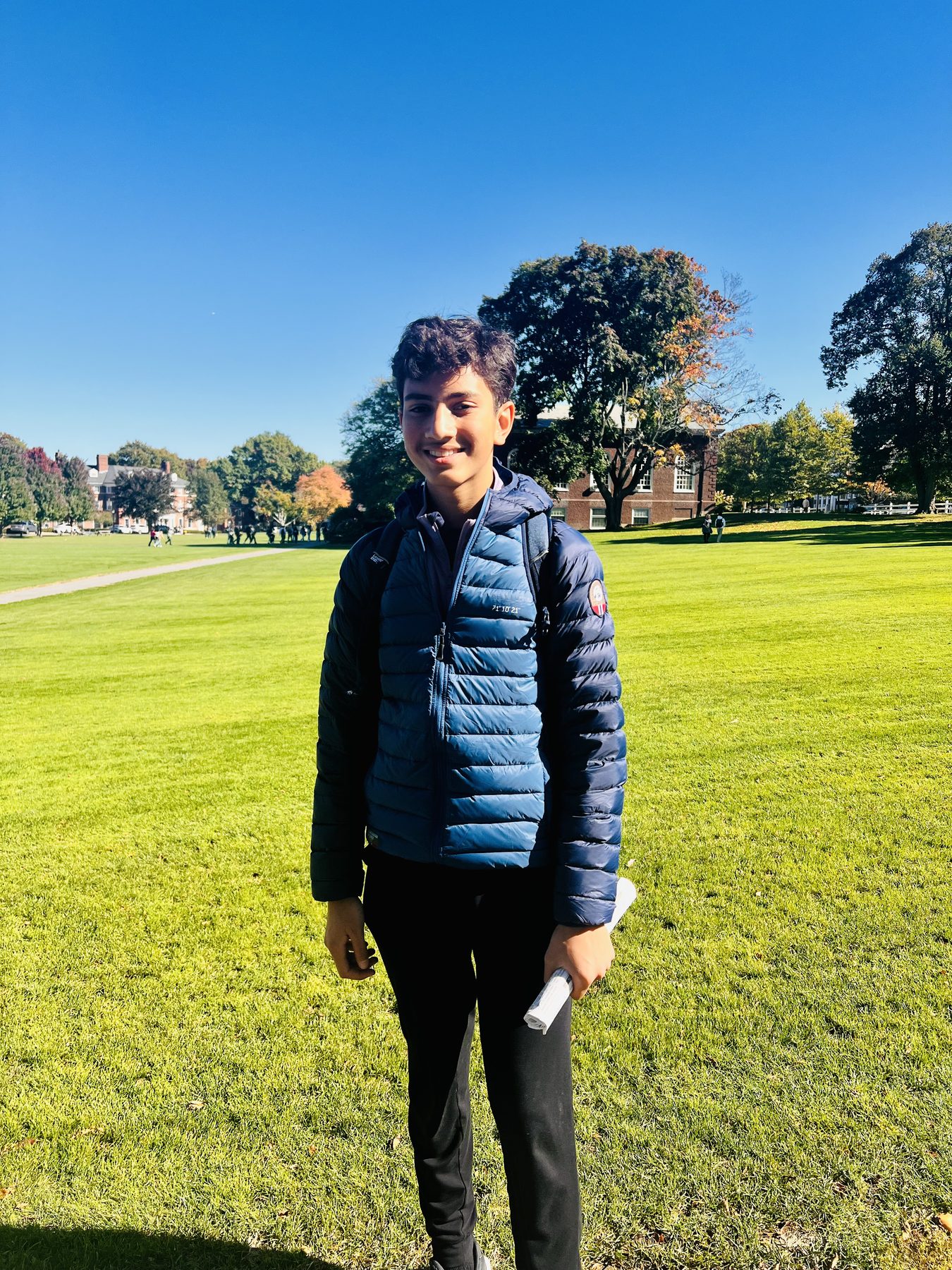 Standing on a college campus lawn during a visit