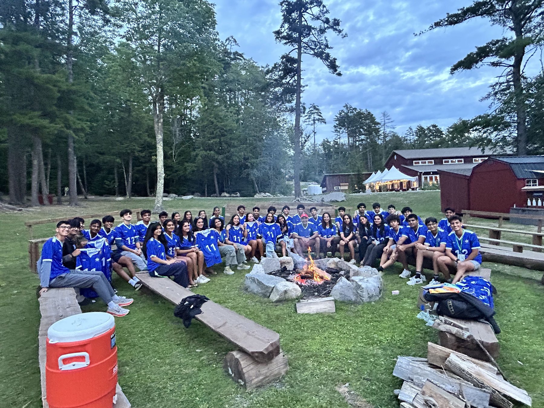 Campers and counselors around the campfire at IFNet camp